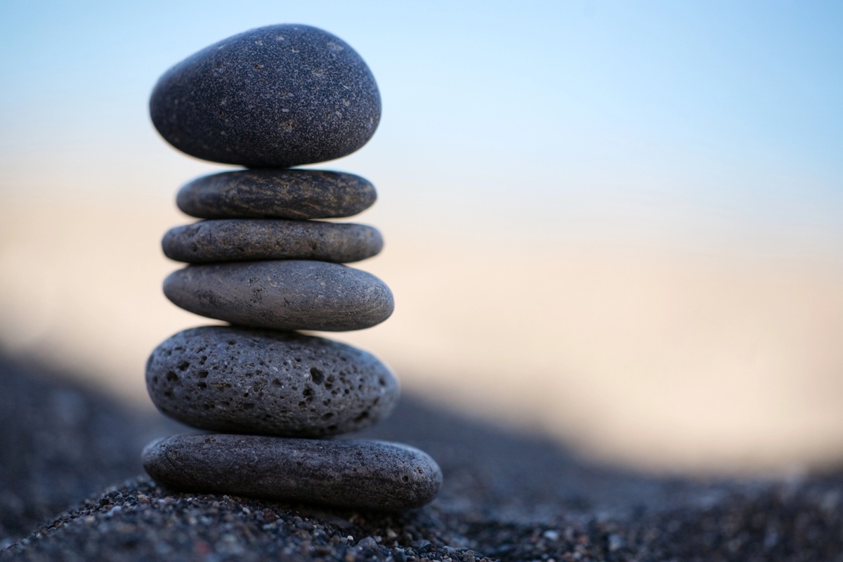 Stack of stones on sandy beach closeup